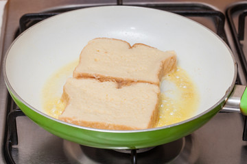 French toast preparation: Cooking french toasts on a pan