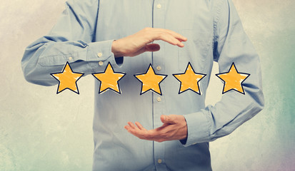 Five Star Rating with businessman on a soft colored wall