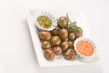 Grilled potatoes with hot pepper sauce.