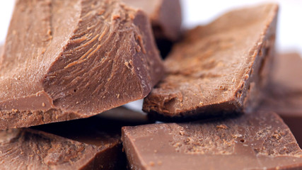 Chunks of chopped premium Belgian Gianduja chocolate macro closeup.