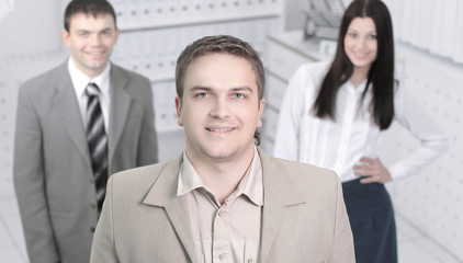 confident young businessman on background of office