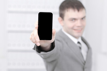 man showing screen of smartphone ,while standing in the office.