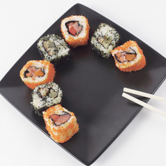 Sushi and rolls. the set is served on a black plate