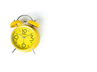 Yellow alarm Clock analog classic retro style on white background , Top view and copy space.