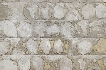 The concrete old wall with the remains of a tile solution from the beaten-off facing tile. Background, texture.