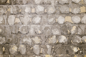 The concrete old wall with the remains of a tile solution from the beaten-off facing tile. Background, texture.