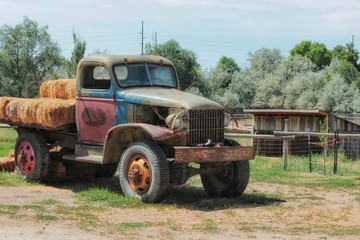 Rusted and old farm vehicle carrying hay bales