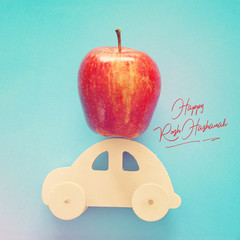 Flat lay image of red fresh apple over wooden car. Rosh hashanah (jewish New Year holiday) concept. Apple - Traditional symbol.