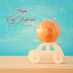 image of red fresh apple over wooden car. Rosh hashanah (jewish New Year holiday) concept. Apple - Traditional symbol.