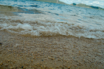 beach with sand near the water, on the shore of the lake