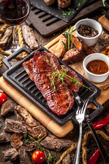 Arabian cuisine in Dubai. A roasted beef steak, with sauce, on a wooden board. The concept is a beautiful serve in the restaurant. Background image. Copy space, selective focus