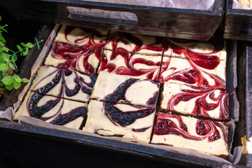 Closed up Raspberry and Blueberries swirled Cheesecake Brownie in tray