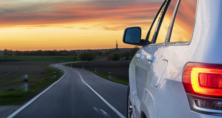 modern SUV on the German road at sunset