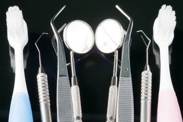 Dental tools use for dentist in the office or clinic. On the black background.