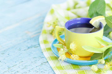 Cup of herbal tea with linden blossoms and lemon