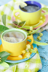Cups of herbal tea with linden blossoms and lemon