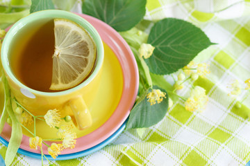 Cup of herbal tea with linden blossoms and lemon