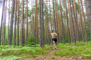 A young man is running along a flattering path