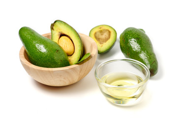 Avocado oil and fresh avocado on white background