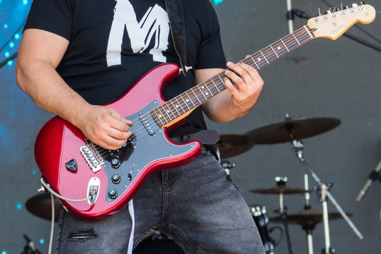 Guitarist  play electricity guitar on concert stage
