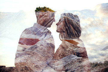 Double exposure man and woman couple hugging with mountains in background. Mountains inside couple...
