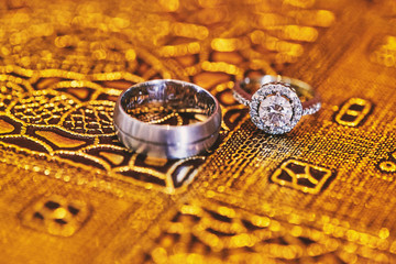 An engagement glitter and shiny rings focusing on the diamond ring of the bride, close-up