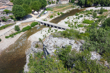 Fototapeta na wymiar View from the viewpoint to the Ardeche, the stone bridge over the Ardeche and the medieval village Labeaume in France