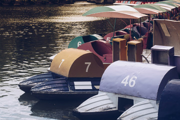 Colorful pedal boats on the lake in the park.