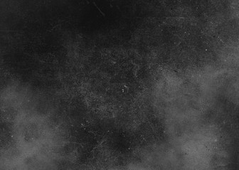 Black abstract textured background texture to the point with spots of paint. Blank background design banner.