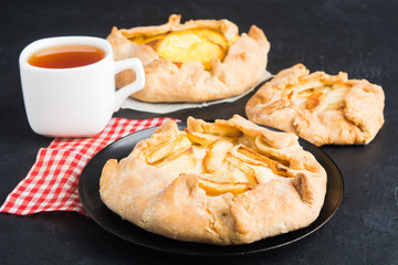 Homemade galette with fruits (apples, apricote) and tea