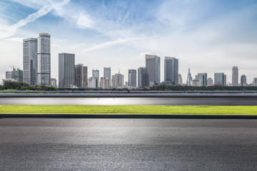 Fototapeta premium Panoramic skyline and modern business office buildings with empty road,empty concrete square floor