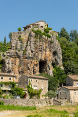 Fototapeta na wymiar View of rocks with cave entrance at the medieval village Labeaume at the river Ardeche in France