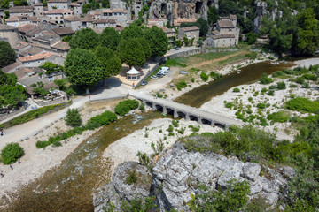 Fototapeta na wymiar View from the viewpoint to the Ardeche, the stone bridge over the Ardeche and the medieval village Labeaume in France