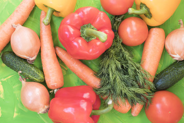 Set of various colorful fresh raw vegetables on a colored background