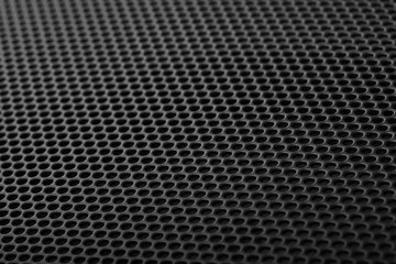 Black speaker grill texture close-up. Background