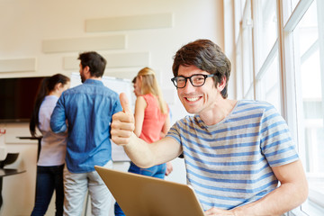 Nerd student holding thumbs up