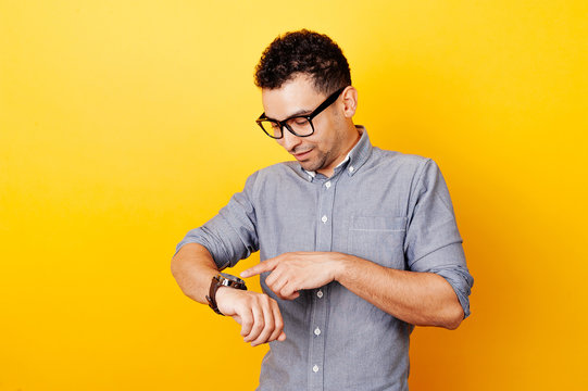 Young man touching smartwatch