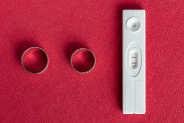 Two wedding rings and a positive pregnancy test