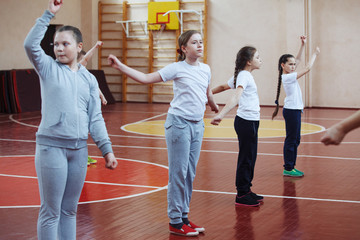 Primary school children a sport lesson indoors