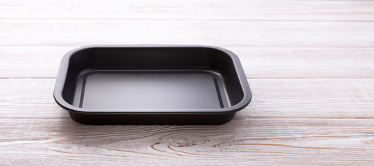 Empty baking tray for pizza close up on wooden background top view horizontally. Mock up for design © missty