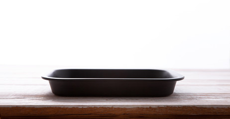 Empty baking tray for pizza close up on wooden background top view horizontally. Mock up for design