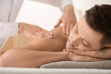 Fototapeta na wymiar Man having massage in spa salon, closeup