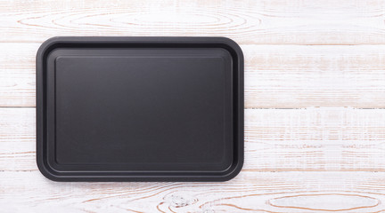 Empty baking tray for pizza close up on wooden background top view horizontally. Mock up for design