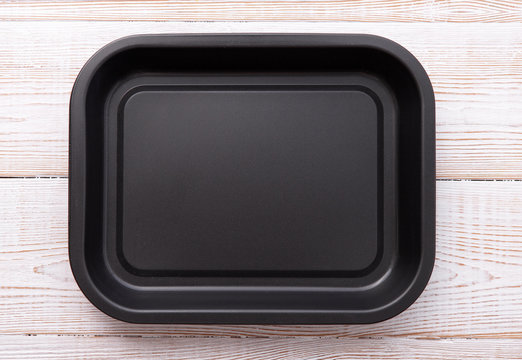 Empty baking tray for pizza close up on wooden background top view horizontally. Mock up for design