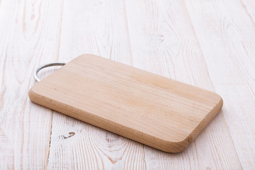 Cutting board on wooden background