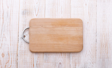 Cutting board on wooden background