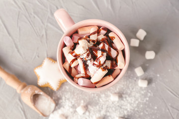 Cup of hot chocolate with marshmallows on table