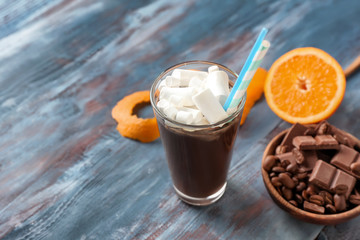 Glass of hot chocolate with marshmallows on wooden table