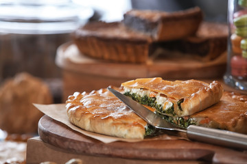 Delicious pie on wooden board in bakery