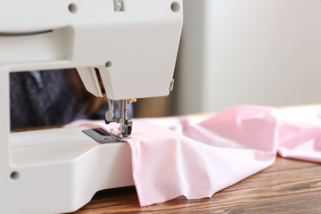 Sewing machine on table in tailor's workshop